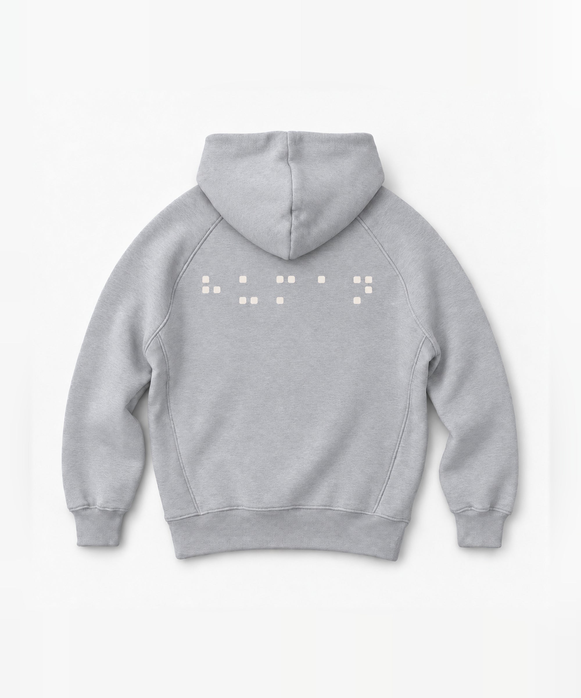 Back mockup of the NAÏYO X Nude Project hoodie with cream square-dot artwork.
