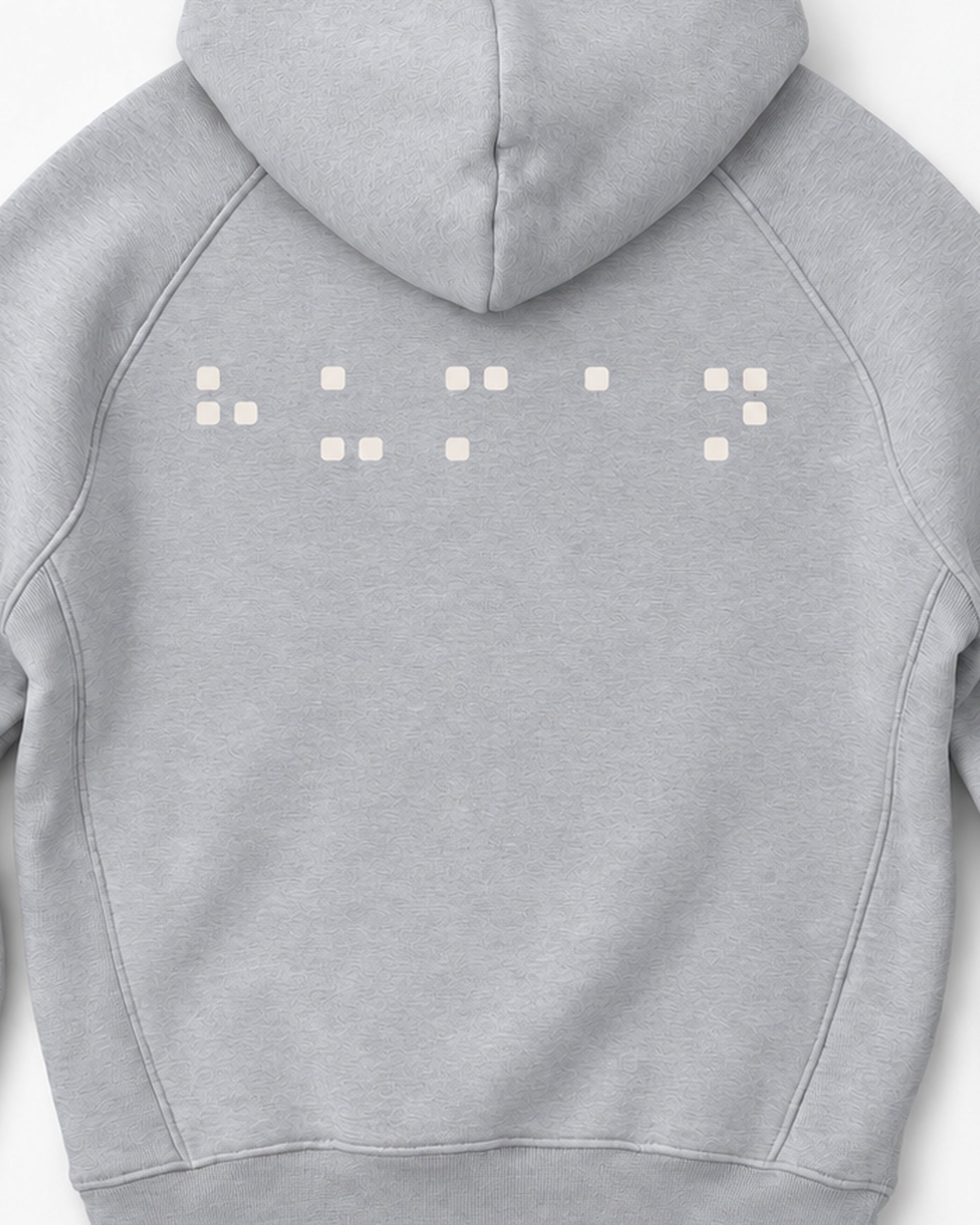 Detail crop of the cream square-dot back print in the grey-melange hoodie mockup.