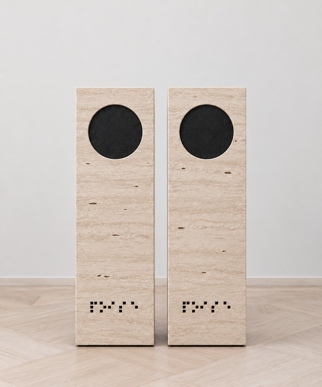 NOISE travertine speakers, close front-facing pair on pale oak parquet.