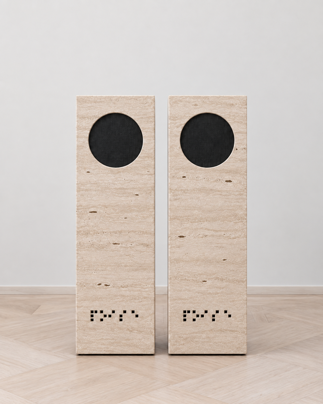 NOISE travertine speakers, close front-facing pair on pale oak parquet.