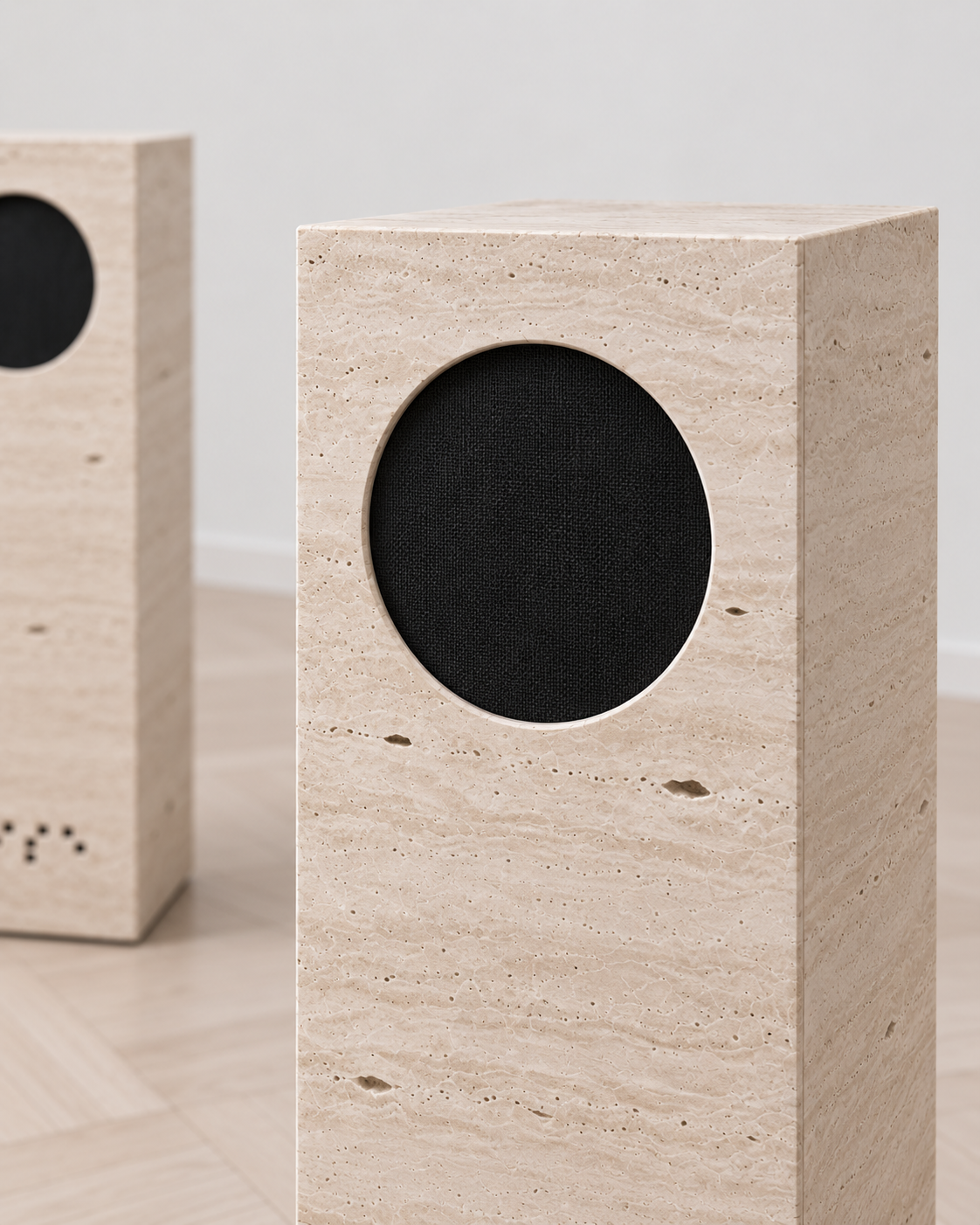 Detail of NOISE circular black woven grille and natural travertine.
